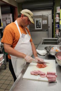 John Magee cutting meat.
