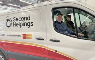 Ivan in the passenger seat of a Second Helpings van.